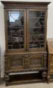 Early 20th century solid oak display cabinet with heavy carving & on bulbous front supports. Ht