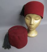 Two Tommy Cooper fez hats - one stamped inside H&P 7 1/8 1955 with war department broad arrow and