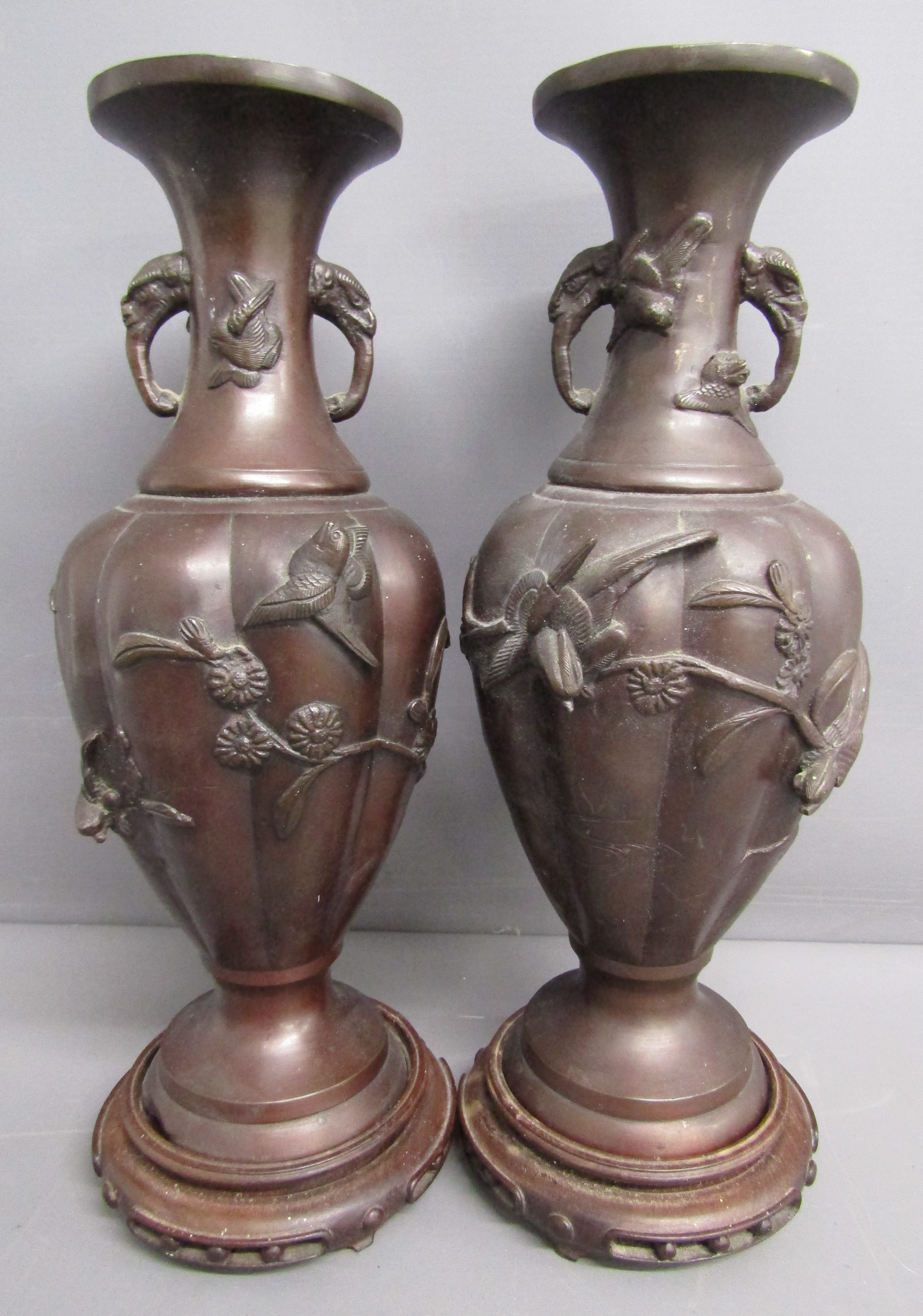 Pair Japanese Meiji period bronze vases decorated with relief decoration of birds and flowers -