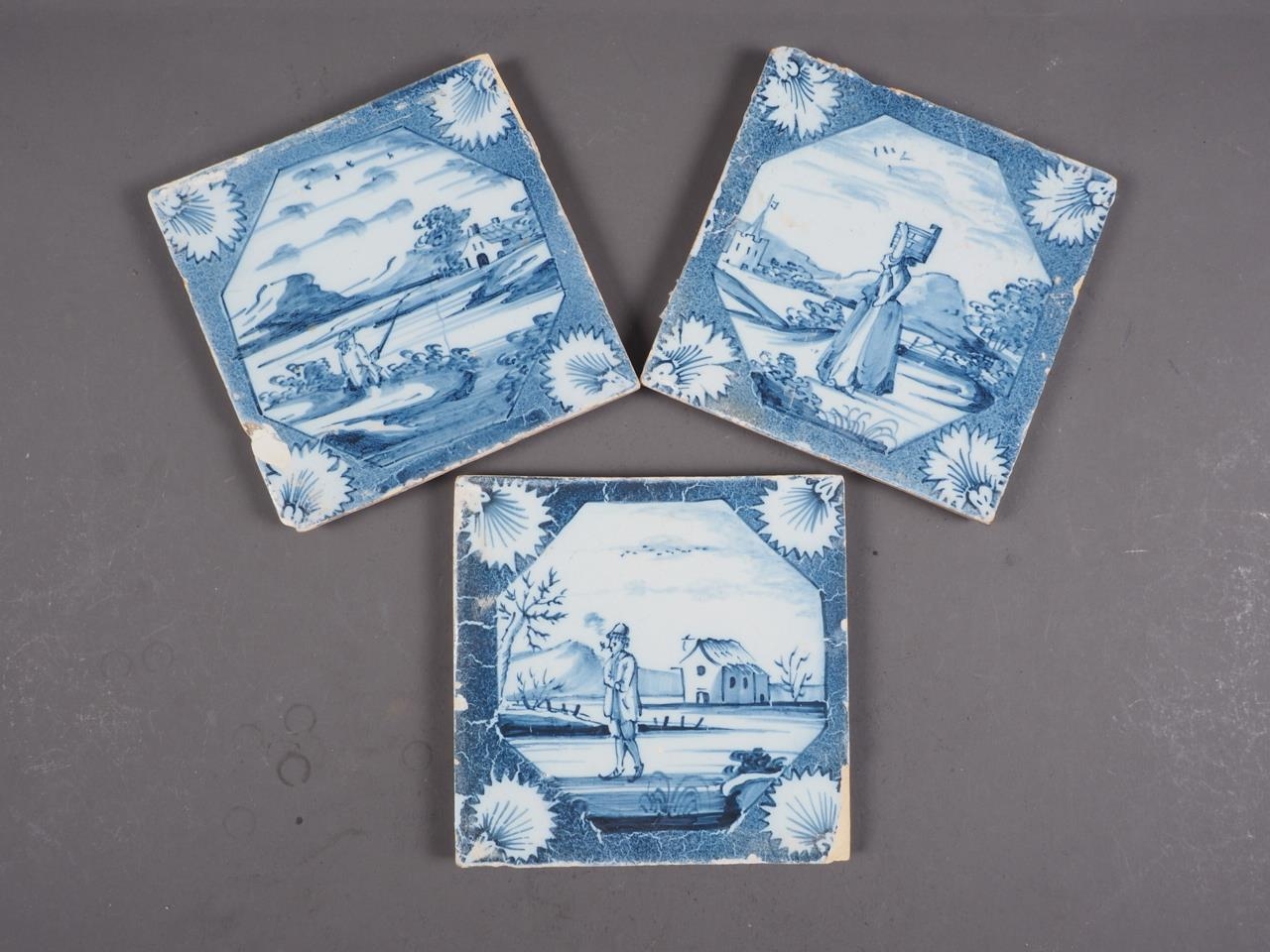 Three early 18th century Lambeth? delft blue and white tiles with figures in landscapes (Archer