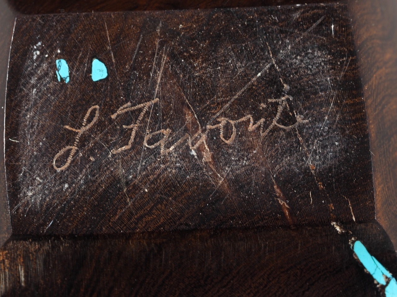 A carved American ironwood and turquoise inlaid abstract model of a ...
