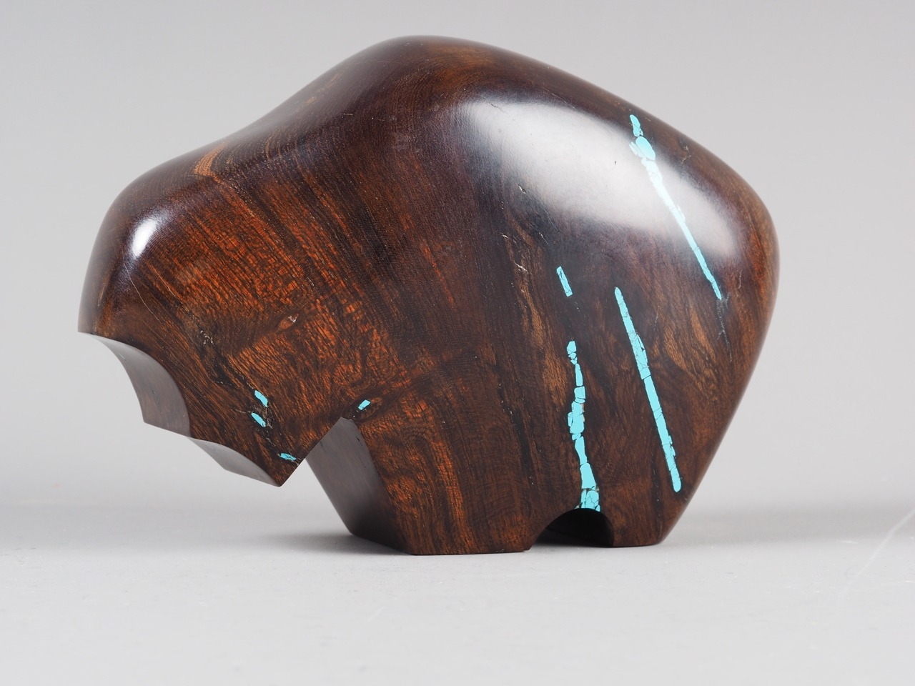 A carved American ironwood and turquoise inlaid abstract model of a ...