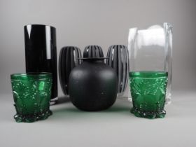 A set of three black glass fluted vases and five other modern glass vases