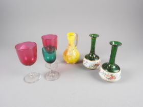 A pair of small green and white cameo glass bottle vases decorated floral band, a pair of ruby