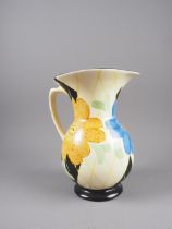 An early 20th century Arthur Wood jug with hand painted floral decoration, 8” high