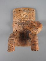 A pre-Columbian Quimbaya terracotta seated figure, 8" high (one arm missing)