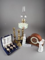 A brass oil lamp with painted reservoir and twisted brass column, oak cased mantel clock, a pair