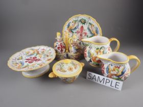 An Italian tin glazed part combination service with central fleur-de-lys surrounded by scrolled