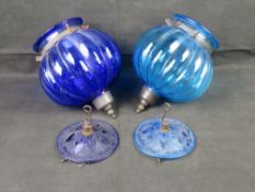 Two vintage glass hanging light shades in blue.