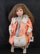 A late 20th century porcelain doll.