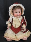 An Armand Marseilles bisque head doll, A.13.M, 990, having sleepy eyes, open mouth and rosy cheeks.