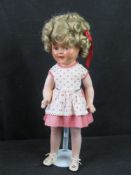 A Shirley Temple doll, 16.