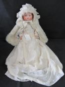An Armand Marseilles bisque head baby doll, 3418, cloth body, sleepy eyes and closed mouth.