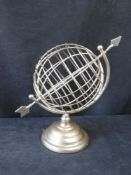 A contemporary armillary arrow globe.