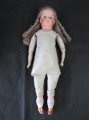 A bisque head doll having leather body, blue eyes and closed mouth,