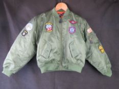 An age 12-13 bomber jacket by Kombat military products.