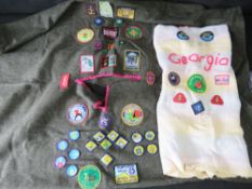 Two Scouts ponchos having various badges upon.