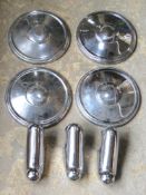 A set of four Armstrong Siddley hubcaps and set of fender clips.