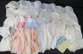 A quantity of vintage and antique clothes, mostly baby or small child,