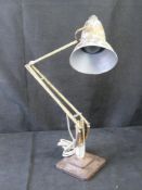 A vintage anglepoise lamp with cast iron base.