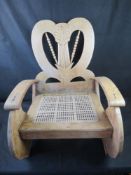 A contemporary carved low 'fireside' chair.