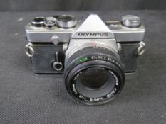 An Olympus OM-1 camera. Disclaimer: electrical items are sold as untested and without guarantee.