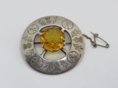 A Scottish silver brooch, hallmarked for Glasgow and having large central orange coloured stone.