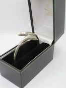A 925 silver dolphin bangle in presentation box.
