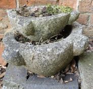 A pair of graduated plant pots, stacked.