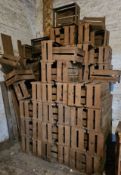 A large stack of vintage fruit crates, estimated to be 100 items.