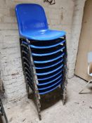 Ten blue plastic stacking chairs.