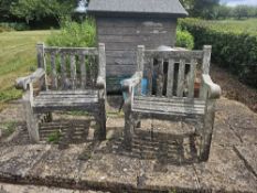 A pair of substantial garden chairs.