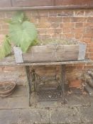 A Singer sewing machine base, stone slab top a/f.