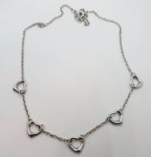 A silver heart necklace.