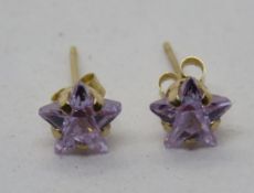 A pair of purple star stud earrings, 9ct marks to butterfly backs.