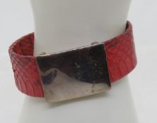A silver and red snake skin bangle, stamped 925, approx 6cm internal dia.