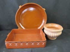 Two large terracotta dishes and a small terracotta planter.