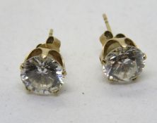 A pair of white stone round stud earrings, 9ct marks to butterfly backs.