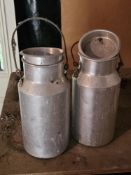 Two small steel milk churns.