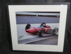 Signed by John Surtees; Photographic print of John Surtees in his Scuderia Ferrari Nurburgring 1965,