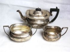 A hallmarked silver tea service comprising teapot with Welsh inscription below,