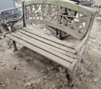 A cast iron and wooden slatted garden bench.