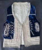 An antique blue velvet waistcoat.