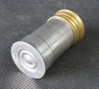 A coin holder in the form of a shotgun cartridge., brass and silver plate.