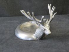 A Culinary Concepts stag head wine bottle coaster.