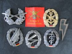 A quantity of reproduction WWII badges.