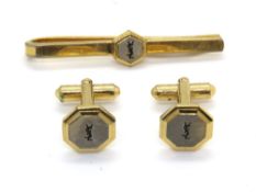 A Yves Saint Laurent tie clip and cufflinks