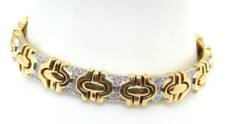 An 18ct gold articulated panel bracelet, the white gold panels encrusted with diamonds,