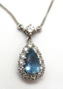 An aquamarine and diamond necklace, the pear shaped aquamarine surrounded by a halo of diamonds,