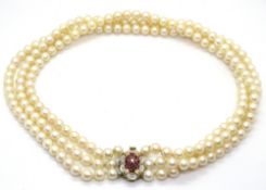 A three strand pearl necklace having 14ct gold clasp set with pink sapphires and diamonds,